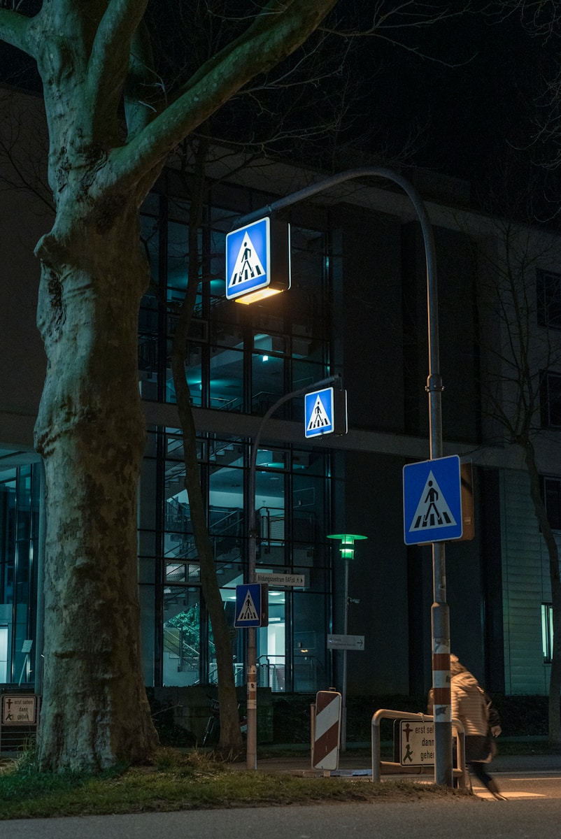 white and blue pedestrian lane sign